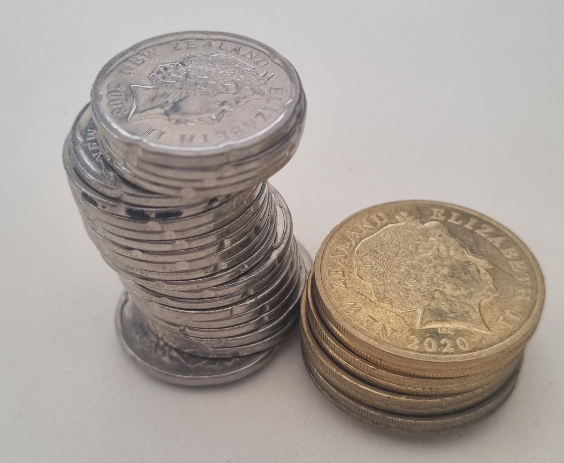 Two stacks of coins arranged on a surface.