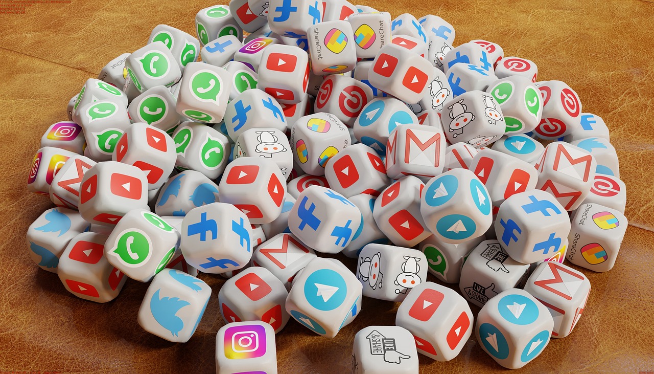 A collection of white dice featuring popular social media platform logos, representing digital marketing, content creation, and social media monetization