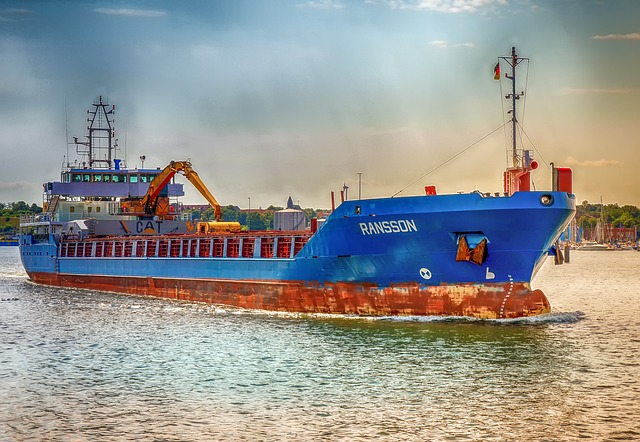 A container ship carrying multiple shipping containers across the ocean, symbolizing global trade and supply chain logistics.