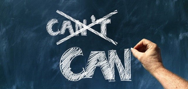 Whiteboard with the word "CAN'T" crossed out in red and replaced with "CAN" in bold letters, emphasizing a shift to a positive mindset.